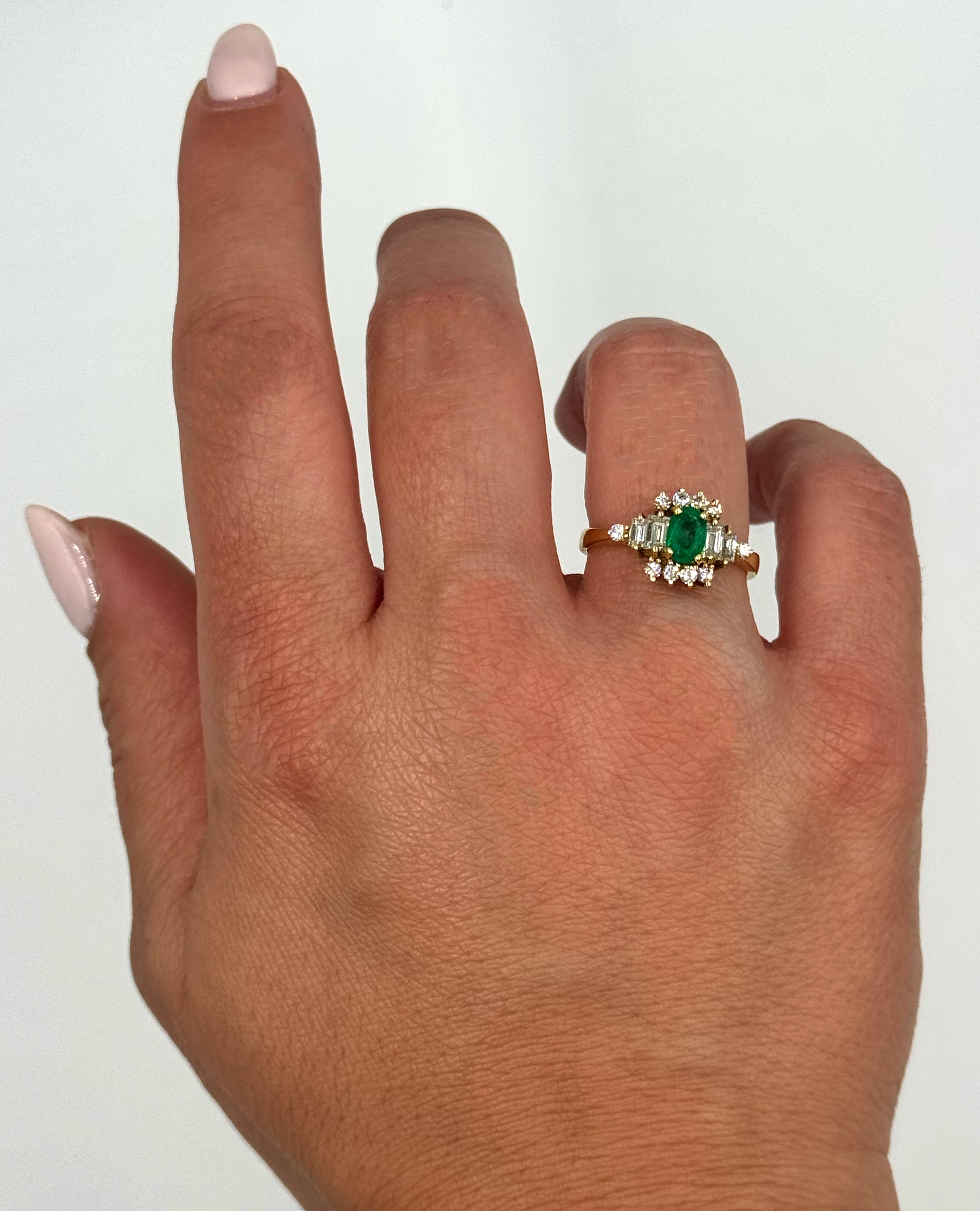 Vintage Oval Emerald Ring with Round and Baguette Diamonds Set in 18K Yellow Gold