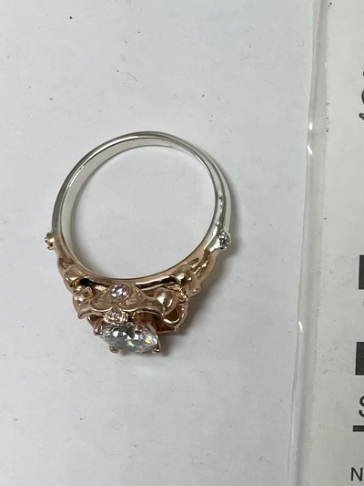 Repair: Silver Swarovski ring, add rose gold plating on top half of ring, polish, leave shank silver