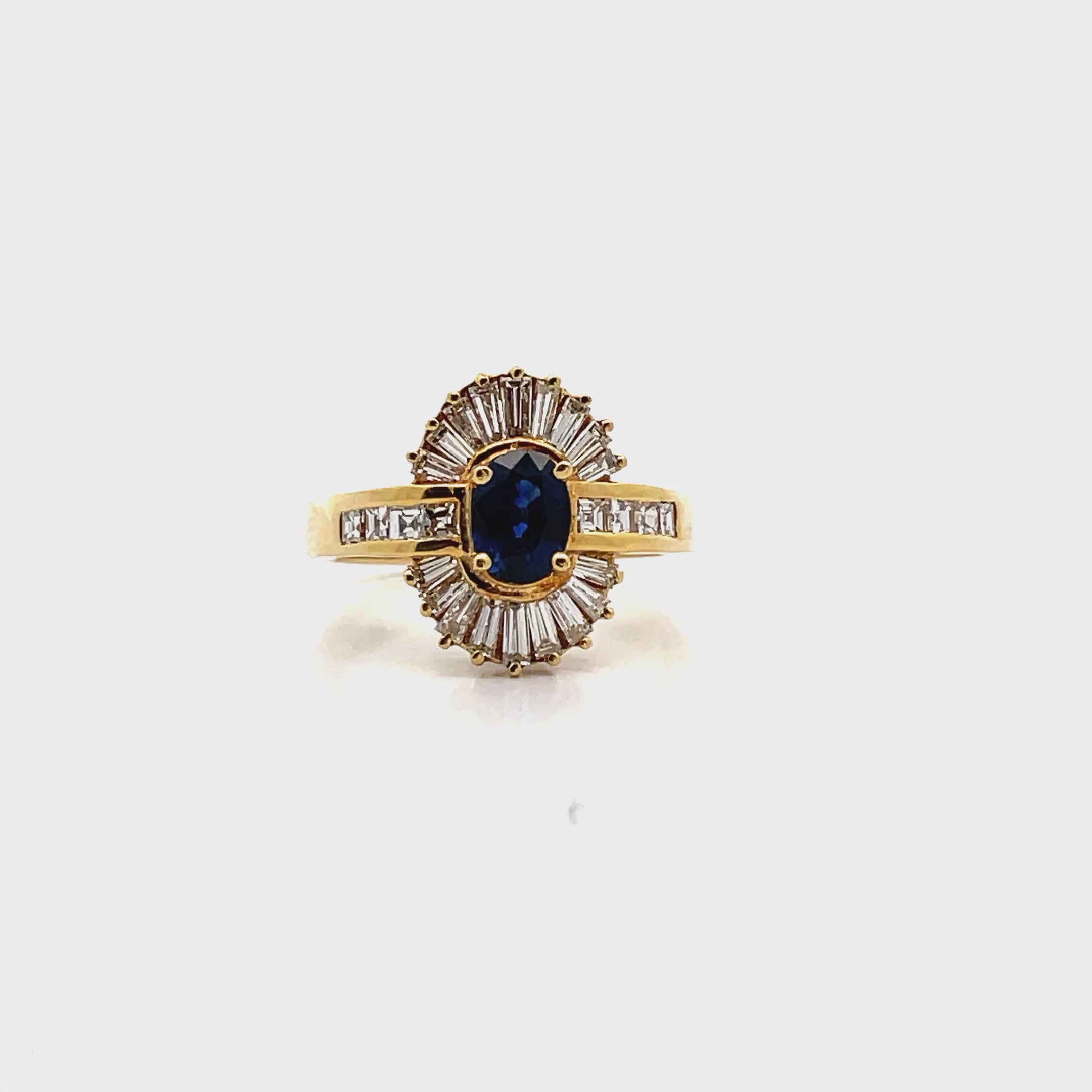 Vintage Oval 0.77 Carat Sapphire Ring with Baguette and Princess Cut Diamonds Set in 18K Gold